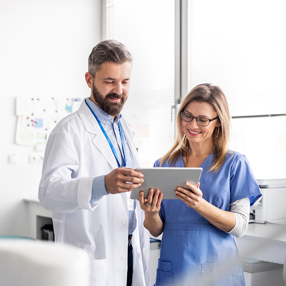 Dentist and dental team member looking at tablet