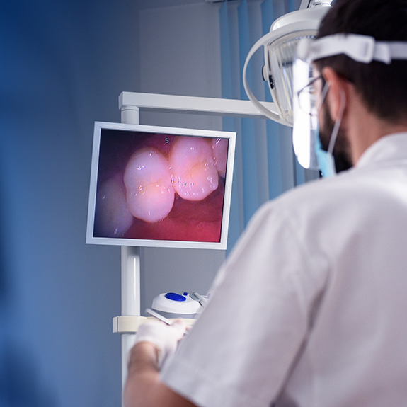 Looking at patient's teeth on monitor