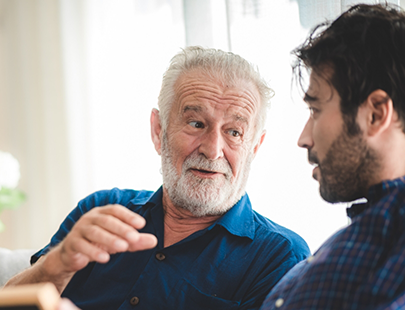 Bearded senior man talking to another man