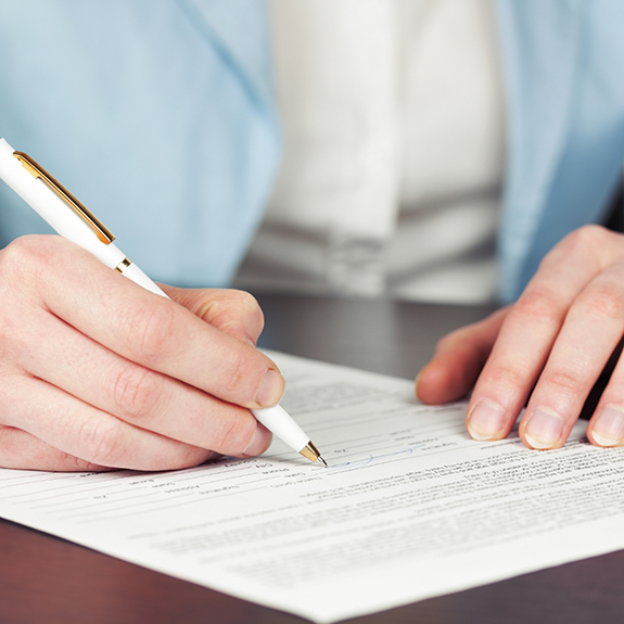 Close up of patient filling out a form