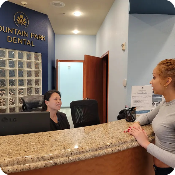 Dental patient talking to team member at front desk