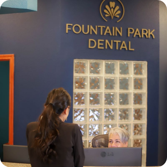 Patient walking up to front desk of dental office