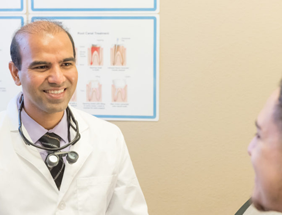 Dr. Chaudhari talking to female patient