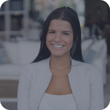 Woman in white jacket standing and smiling