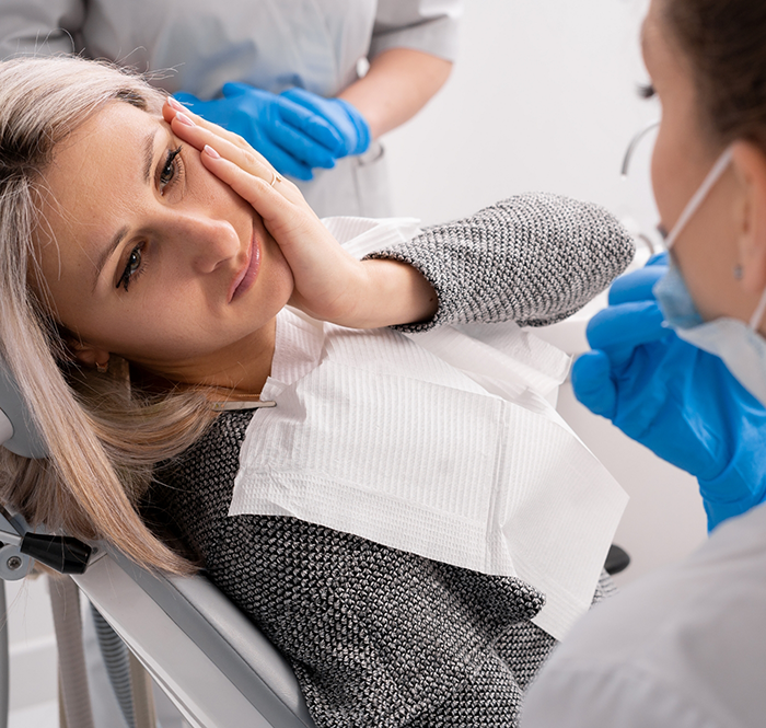 Woman in dental chair with tooth pain